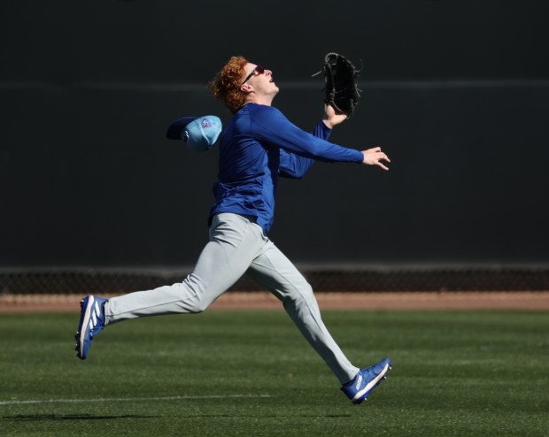 Chicago Cubs outfielder Owen Caissie loses his hat as he chases down a fly ball at practice on Thursday, Feb. 22, 2024, at Sloan Park in Mesa, Arizona. (Stacey Wescott/Chicago Tribune)