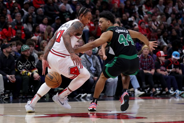 Chicago Bulls forward DeMar DeRozan (11) dribbles behind his back as he tries to elude Boston Celtics guard Jaden Springer (44) in the second half of a game at the United Center in Chicago on March 23, 2024. (Chris Sweda/Chicago Tribune)