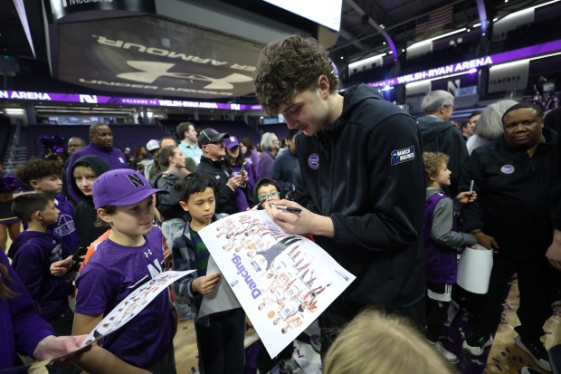 Northwestern Wildcats forward Nick Martinelli (2) signs autographs after the Northwestern Men's Basketball NCAA selection show watch party at Welsh-Ryan Arena in Evanston on Sunday, March 17, 2024. The Northwestern Wildcats will face Florida Atlantic University in the first round of the NCAA Tournament. (Trent Sprague/Chicago Tribune)