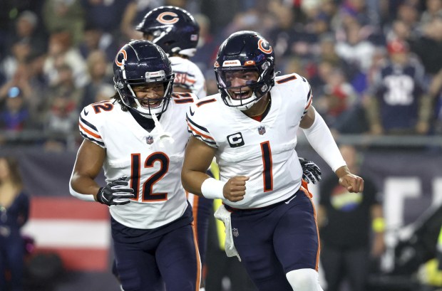 Bears quarterback Justin Fields (1) celebrates with teammate Velus Jones Jr. (12) after Fields scored a rushing touchdown against the Patriots on Oct. 24, 2022, at Gillette Stadium in Foxborough, Mass. (Chris Sweda/Chicago Tribune)