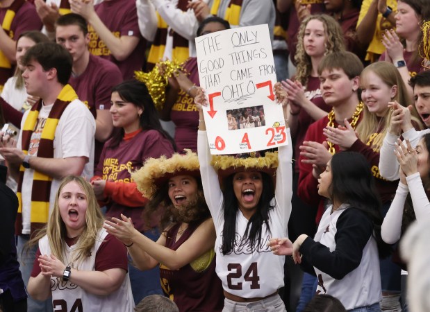 Wearing cowboy hats with feathers, Loyola students Melisa Sulievic, center left, and Nyah Moore cheer on the Ramblers during the first half against the Flyers at Gentile Arena on March 1, 2024. (John J. Kim/Chicago Tribune)
