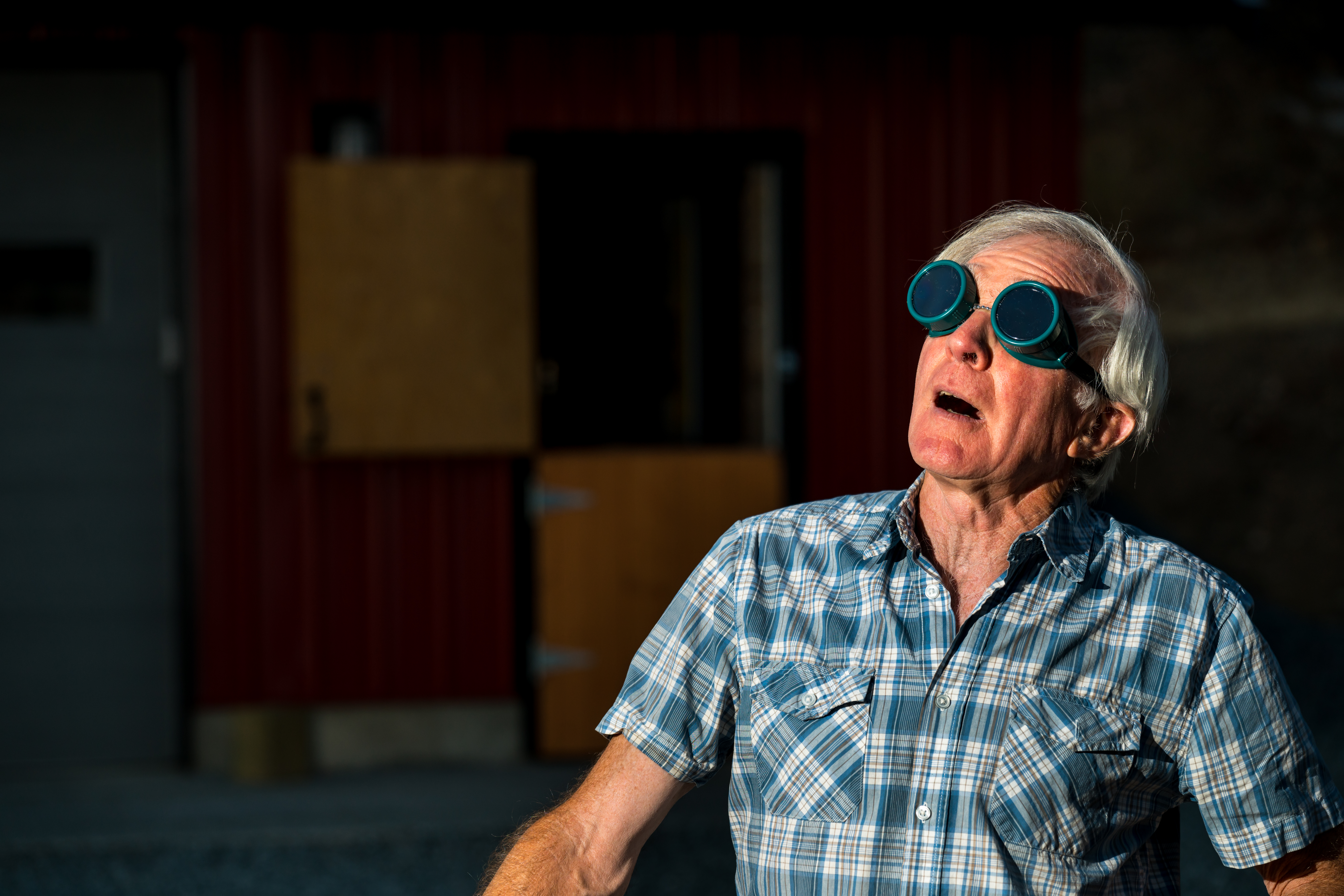 a man in goggles watches the eclipse