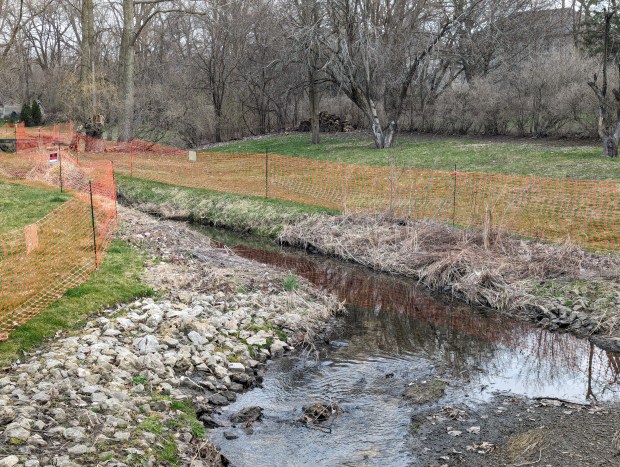 Sections of Mahoney Creek in Batavia were seen to be blocked off with plastic fencing and "no trespassing" signs on Friday as work continues to clean up a chemical foam spill in the waterway. (R. Christian Smith / The Beacon-News)