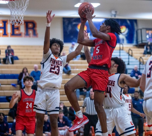 West Aurora's Terrence Smith (5) goes up for a basket against Oswego during a Southwest Prairie Conference game in Oswego on Friday, Dec. 1, 2023.