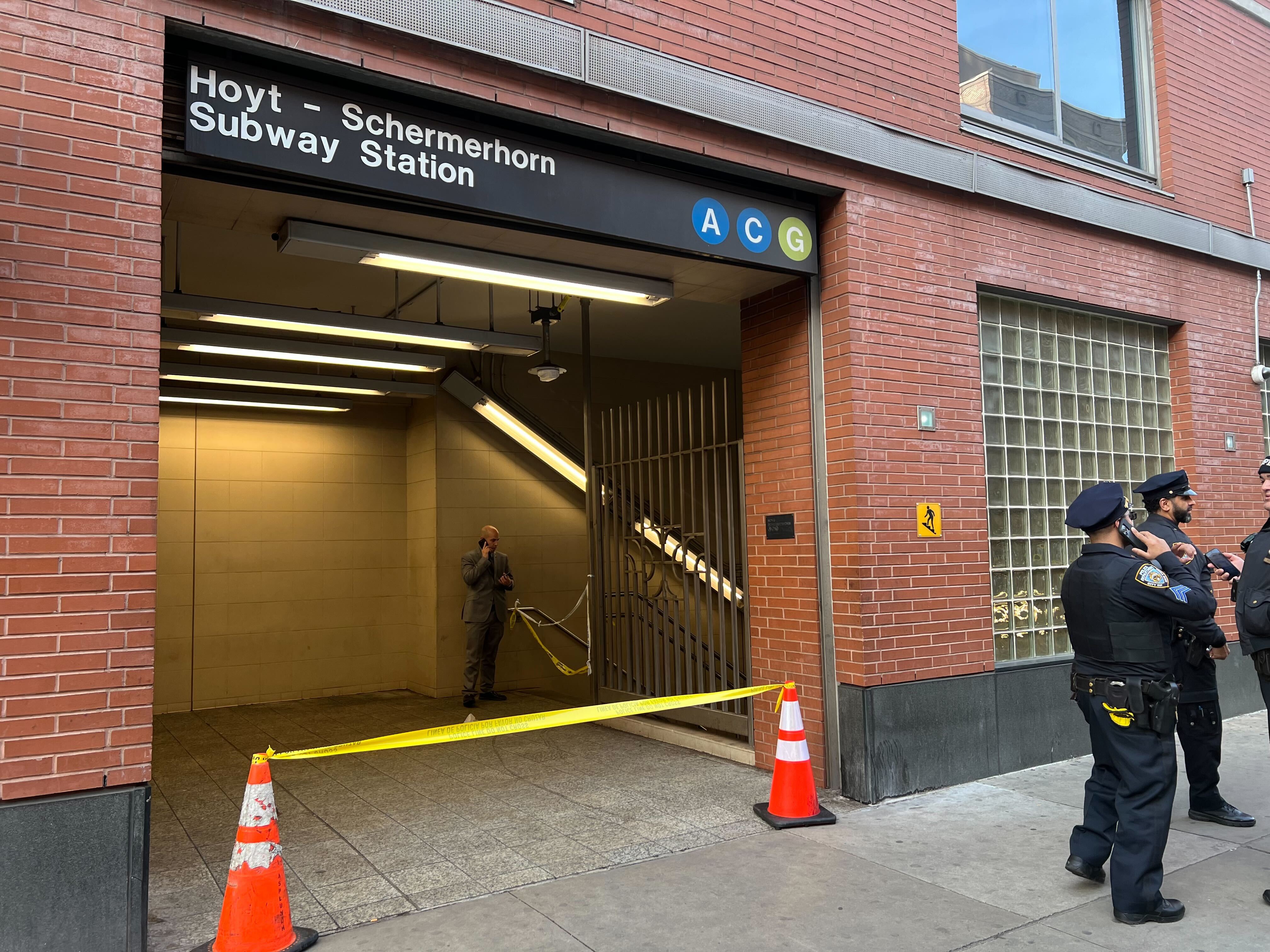 Police tape lines the entrance to the subway in Brooklyn on Thursday after a man was shot.