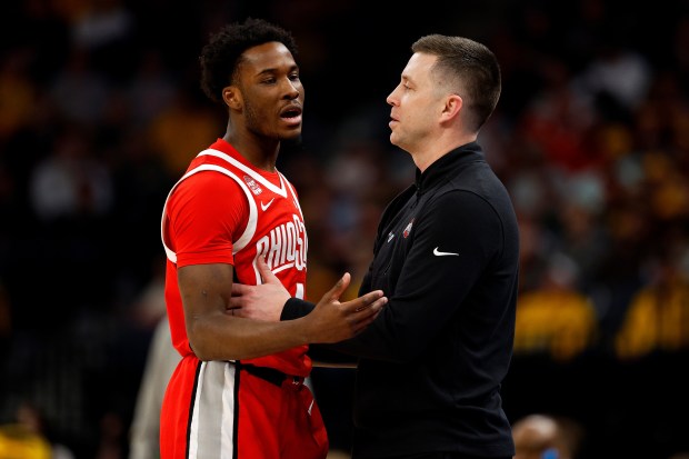 Ohio State interim coach Jake Diebler interacts with Dale Bonner in the second half against Iowa on Thursday, March 14, 2024, in Minneapolis. (David Berding/Getty Images)