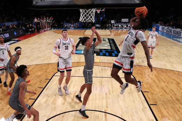 Connecticut guard Tristen Newton, right, goes up for a dunk against Stetson's Aubin Gateretse in the first round of the NCAA Tournament on March 22, 2024, in New York. (Elsa/Getty)