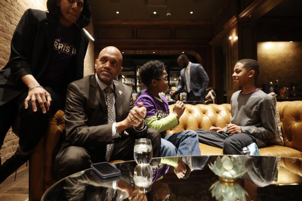 Cook County state's attorney candidate Clayton Harris III, with his wife, Trena, and their children, A.J., 9, and Clayton IV, 11, right, sit in a room before greeting supporters at his campaign's election night gathering at a restaurant in the 200 block of North Canal Street on March 19, 2024, in Chicago. (John J. Kim/Chicago Tribune)