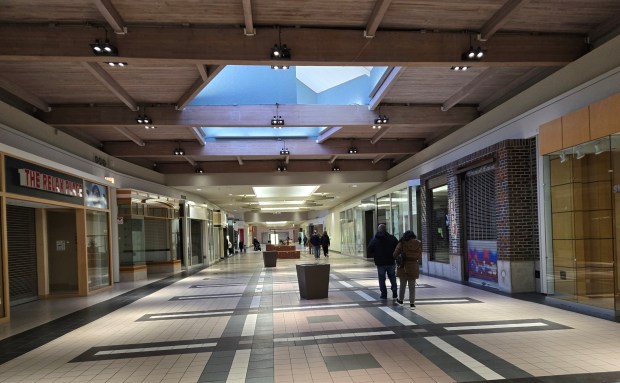 A few people wander through the nearly vacant Spring Hill Mall on its final day Friday. The shopping center, which opened in Oct. 1980, is being purchased by the village of West Dundee for redevelopment. (Gloria Casas/The Courier-News)