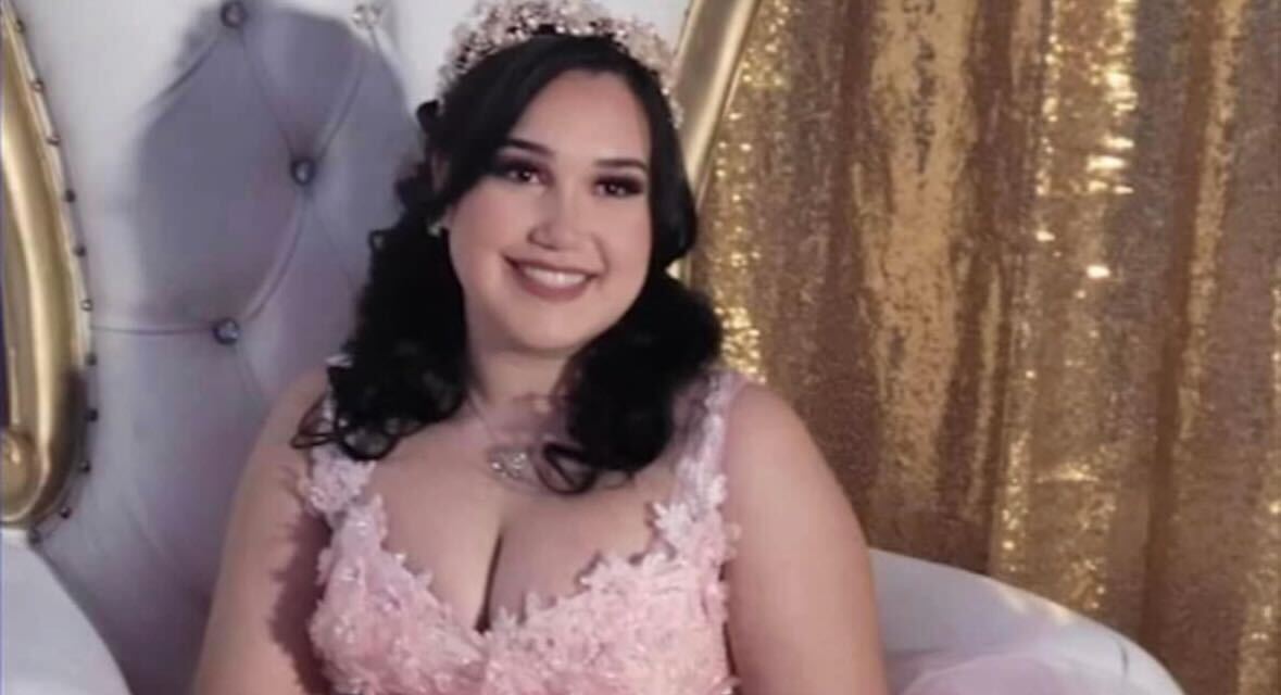 A teen girl smiling in a Sweet 16 dress.