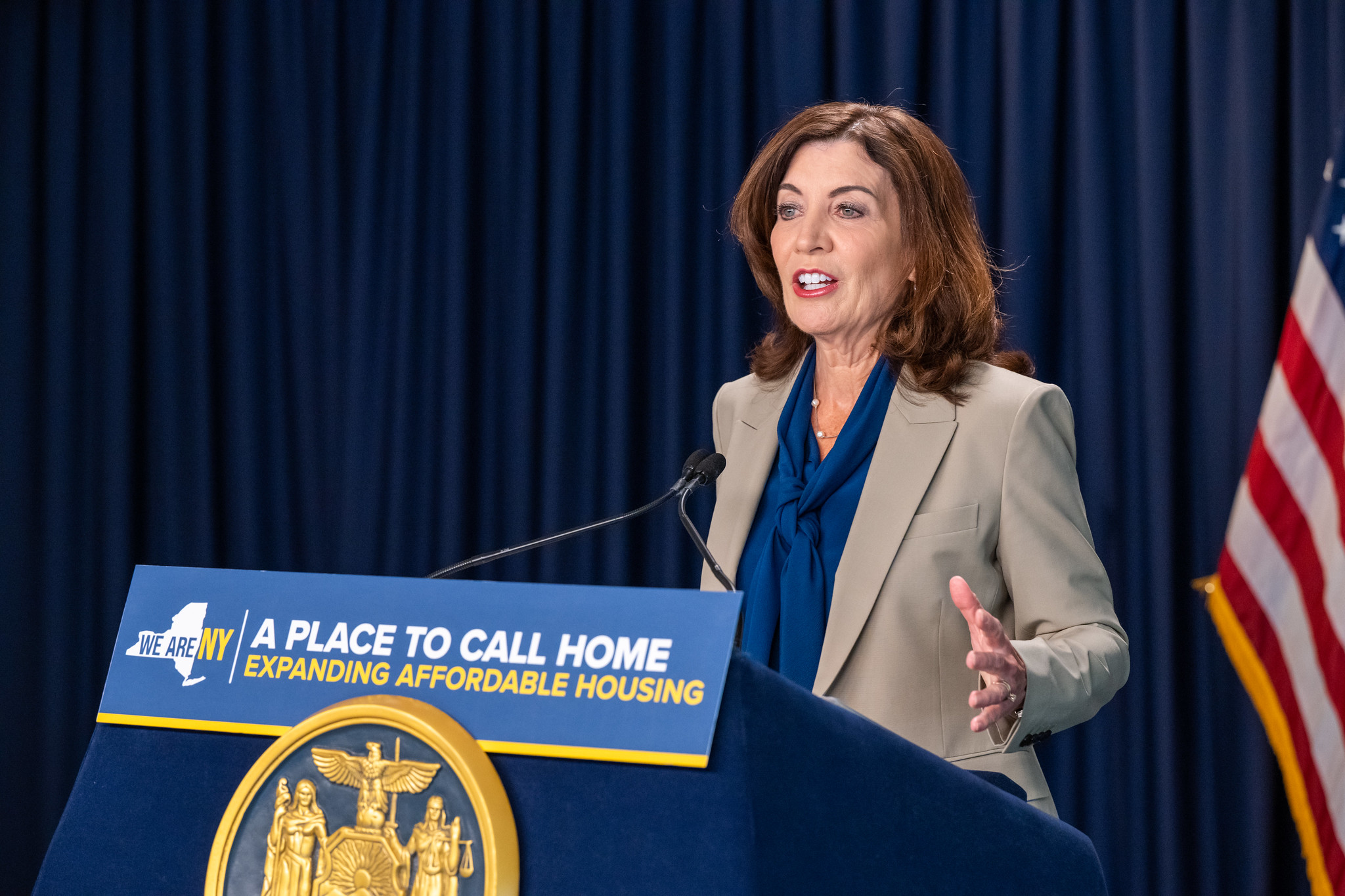 Gov. Kathy Hochul speaking at a press conference behind a podium.