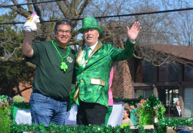 Tinley Park Mayor Michael Glotz, left, and Trustee Bill Brennan wave to the crowd from the village's float Sunday at the Irish Parade. Jeff Vorva /for Daily Southtown, March 3, 2024, Tinley Park Irish Parade, Tinley Park, Illinois