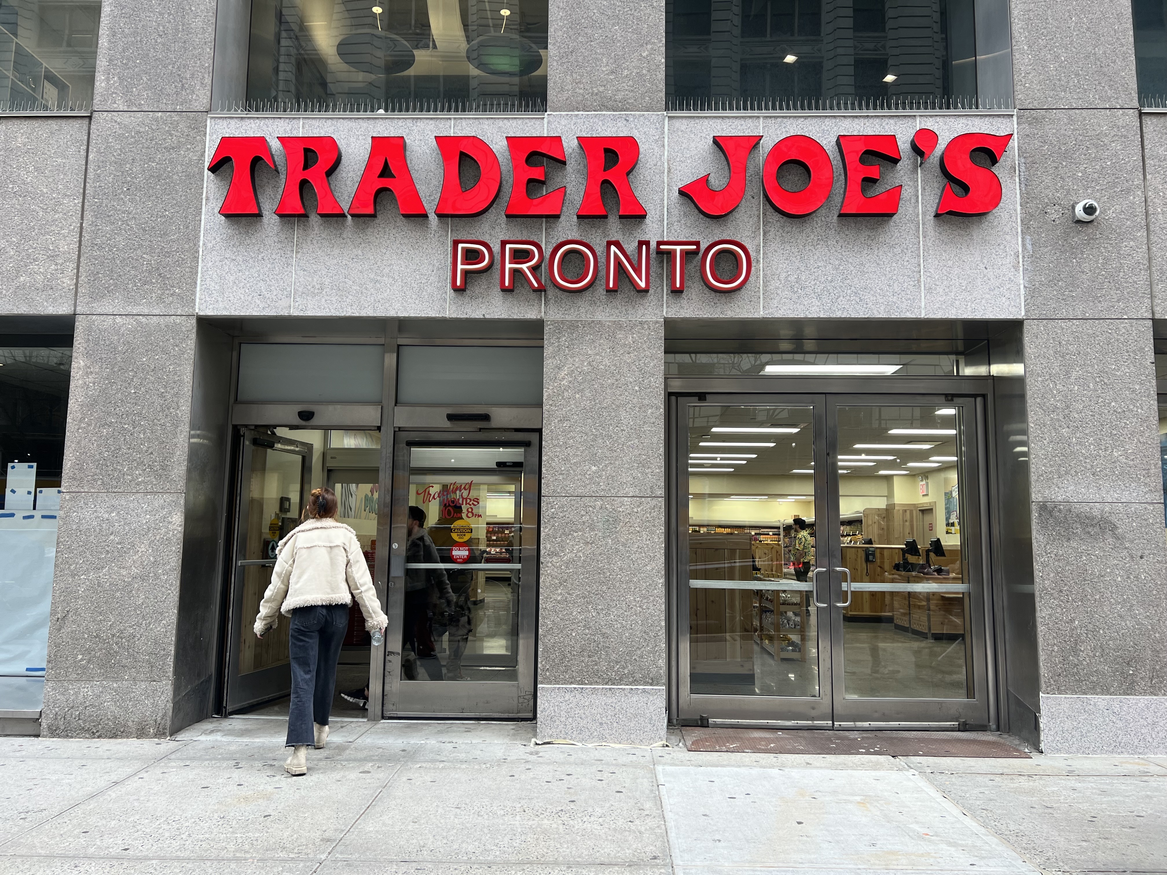 A new sign reads "Trader Joe's Pronto" in place of the former wine shop.