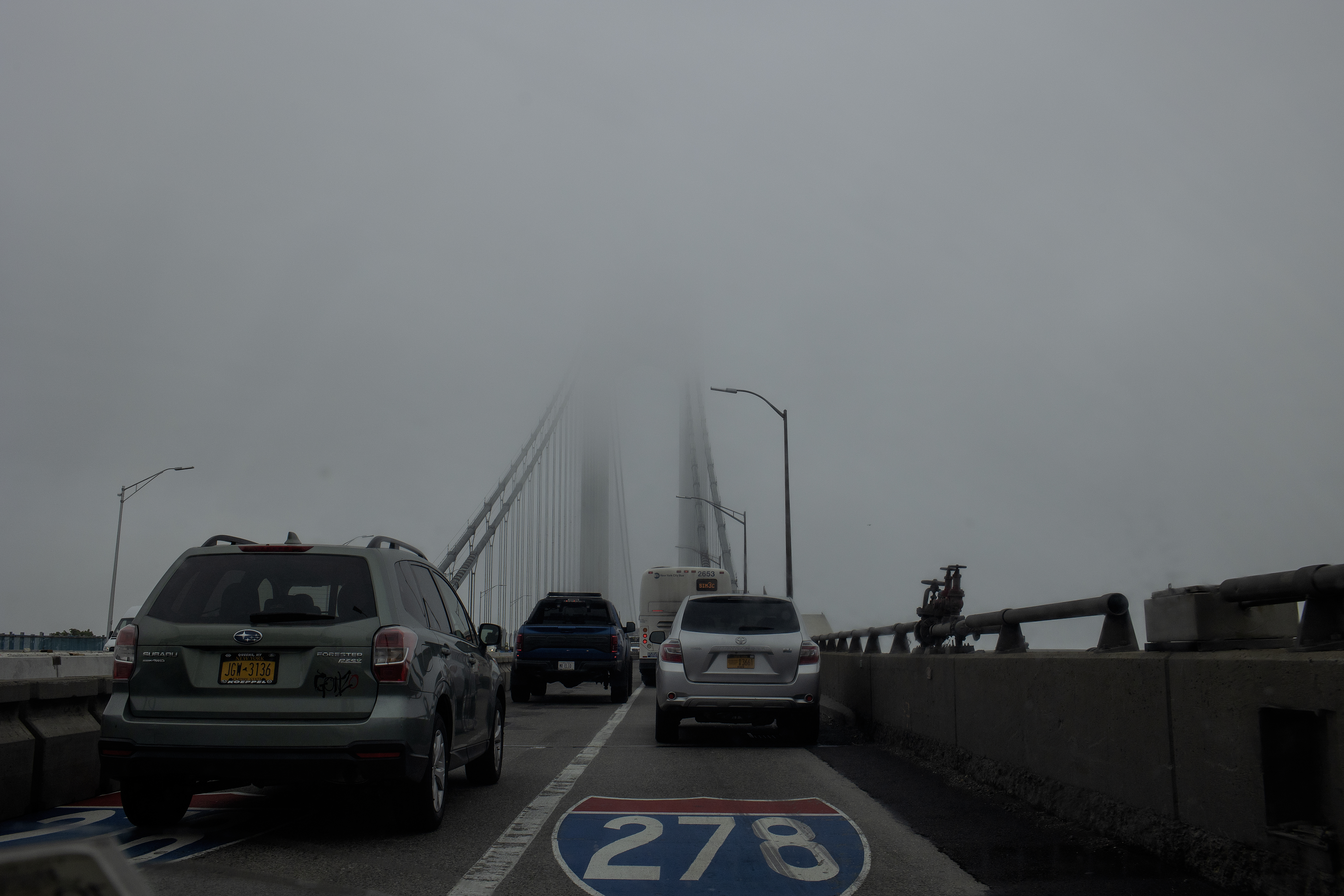 Traffic on the Verrazano bridge on a foggy day.