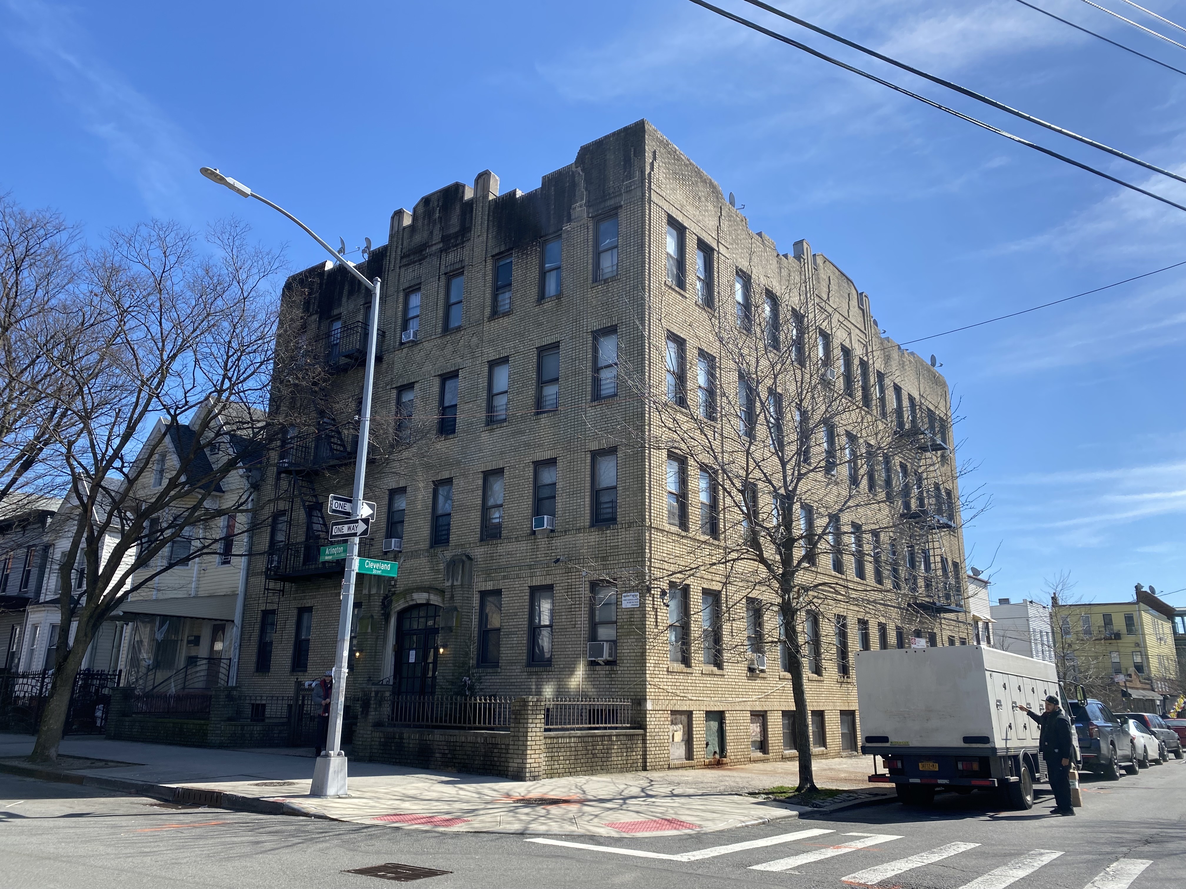 An exterior shot of the four floor brick building in the Cypress Hill neighborhood of East New York.