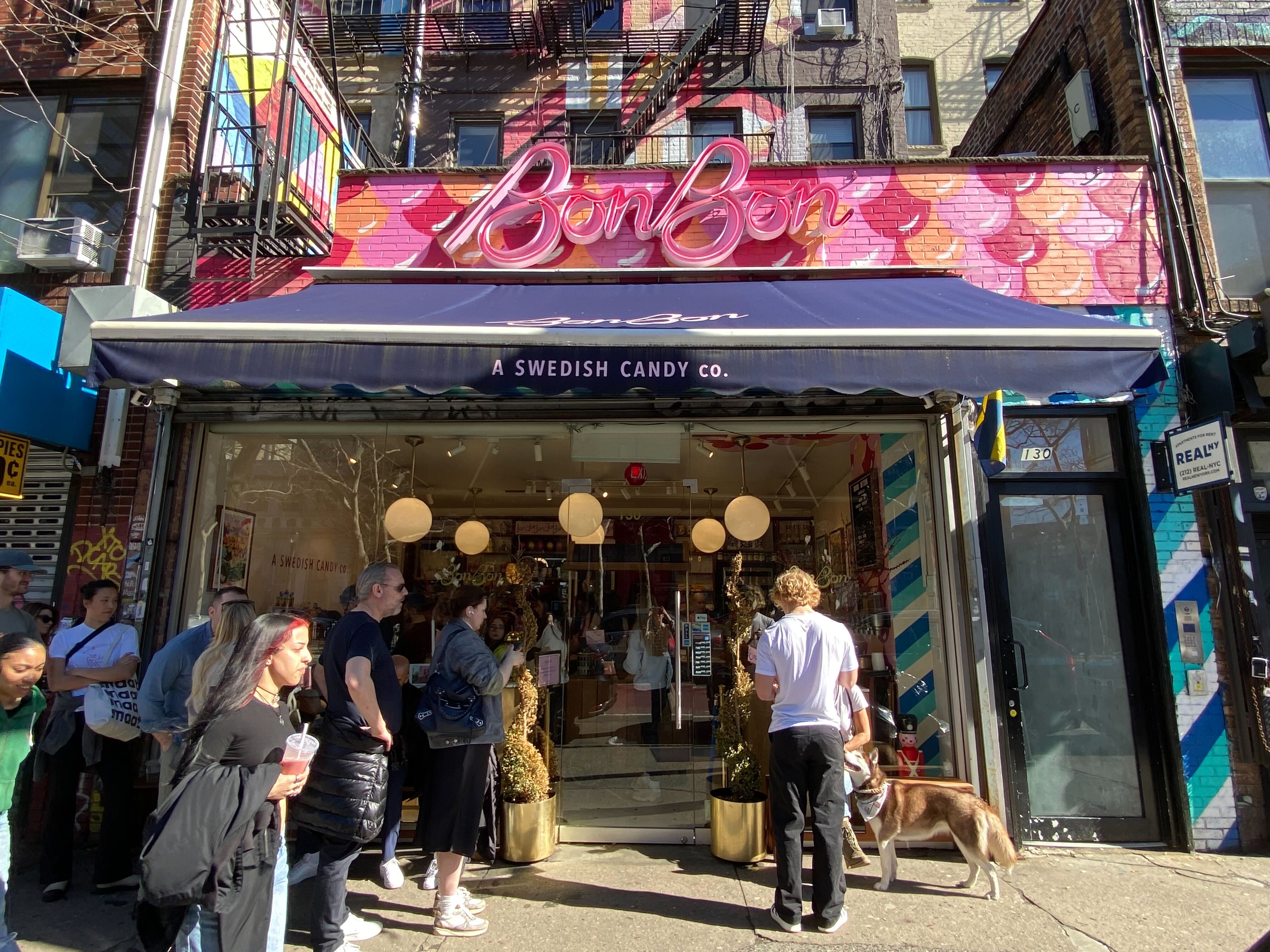 A group of people waits in front of BonBon candy store in the Lower East Side.