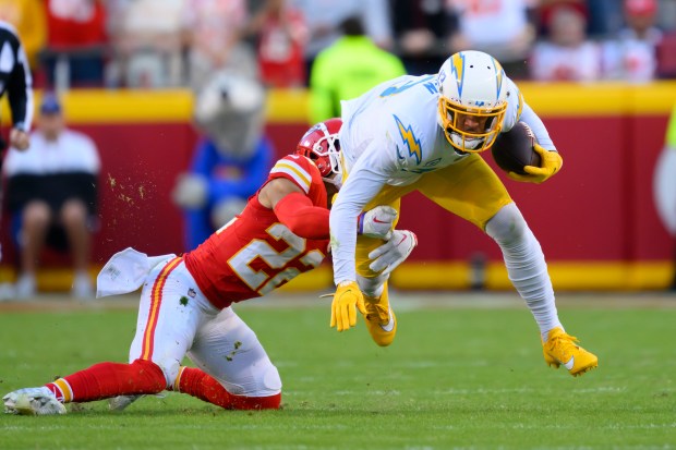 Chiefs cornerback Trent McDuffie tackles Chargers wide receiver Keenan Allen during a game on Oct. 22, 2023, in Kansas City, Mo.