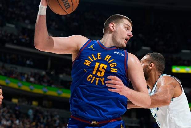 Denver Nuggets center Nikola Jokic (15) and Minnesota Timberwolves center Rudy Gobert (27) in the second half of an NBA basketball game Friday, March 29, 2024, in Denver. (AP Photo/David Zalubowski)