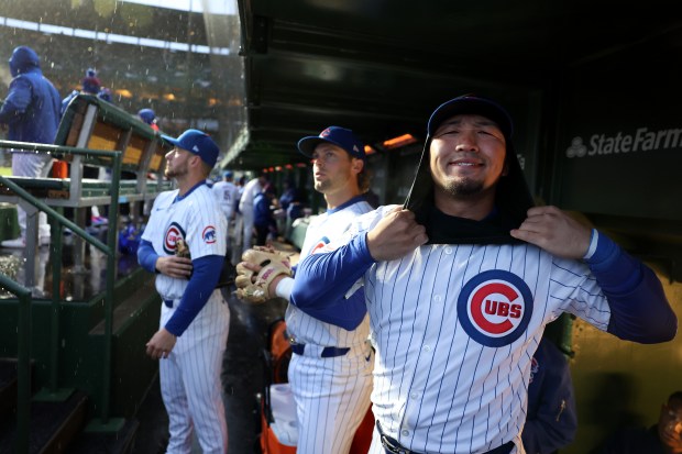 Chicago Cubs right fielder Seiya Suzuki (27) prepares for a cold and rainy game before facing the Colorado Rockies at Wrigley Field in Chicago on Wednesday, April 3, 2024. (Chris Sweda/Chicago Tribune)