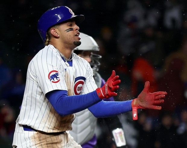Chicago Cubs third baseman Christopher Morel (5) celebrates after sliding in safely at home plate to score on a sacrifice fly in the second inning of a game against the Colorado Rockies at Wrigley Field in Chicago on Wednesday, April 3, 2024. (Chris Sweda/Chicago Tribune)