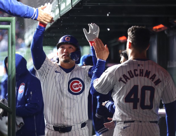 Chicago Cubs right fielder Seiya Suzuki (27) is congratulated in the dugout after hitting a solo home run in the fifth inning of a game against the Colorado Rockies at Wrigley Field in Chicago on Wednesday, April 3, 2024. (Chris Sweda/Chicago Tribune)