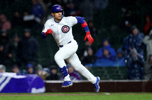 Chicago Cubs catcher Miguel Amaya (9) advances to second base on a throwing error that scored a run after Amaya singled in two runs with a single in the sixth inning of a game against the Colorado Rockies at Wrigley Field in Chicago on Wednesday, April 3, 2024. (Chris Sweda/Chicago Tribune)