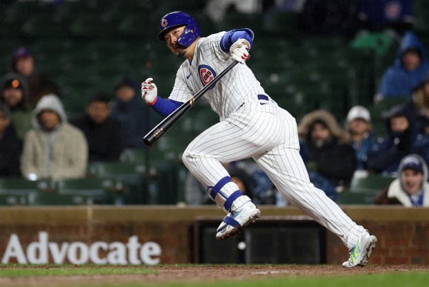 Chicago Cubs right fielder Seiya Suzuki (27) sprints to first base with an infield single in the sixth inning of a game against the Colorado Rockies at Wrigley Field in Chicago on Wednesday, April 3, 2024. (Chris Sweda/Chicago Tribune)