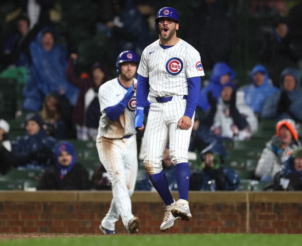 Chicago Cubs baserunner Mike Tauchman (40) celebrates after sliding in safely at home plate to score on a throwing error that resulted from a two-run single by Cubs catcher Miguel Amaya in the sixth inning of a game against the Colorado Rockies at Wrigley Field in Chicago on Wednesday, April 3, 2024. (Chris Sweda/Chicago Tribune)