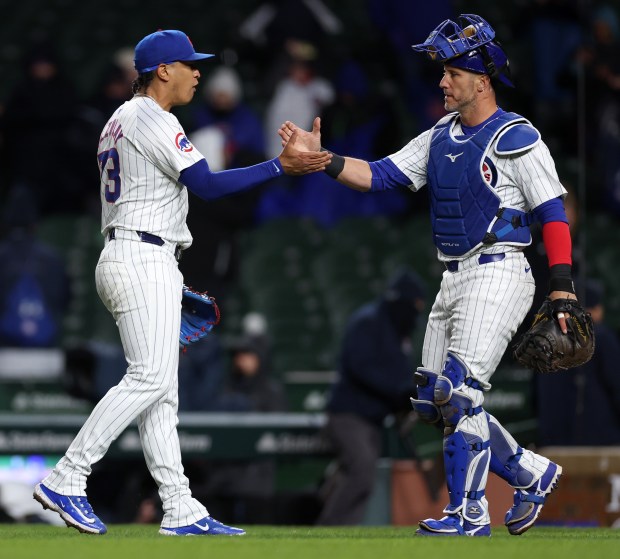 Chicago Cubs relief pitcher Adbert Alzolay (73) celebrates with catcher Yan Gomes (15) after the duo closed out the Colorado Rockies in the ninth inning of a game at Wrigley Field in Chicago on Wednesday, April 3, 2024. (Chris Sweda/Chicago Tribune)