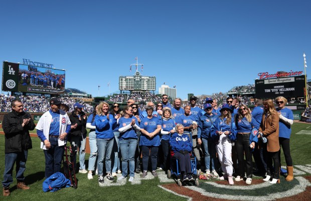Relatives and friends of former Cubs clubhouse manager Tom "Otis" Hellmann gather at home plate to remember Hellman before a game against the Dodgers at Wrigley Field on April 6, 2024, in Chicago. (John J. Kim/Chicago Tribune)