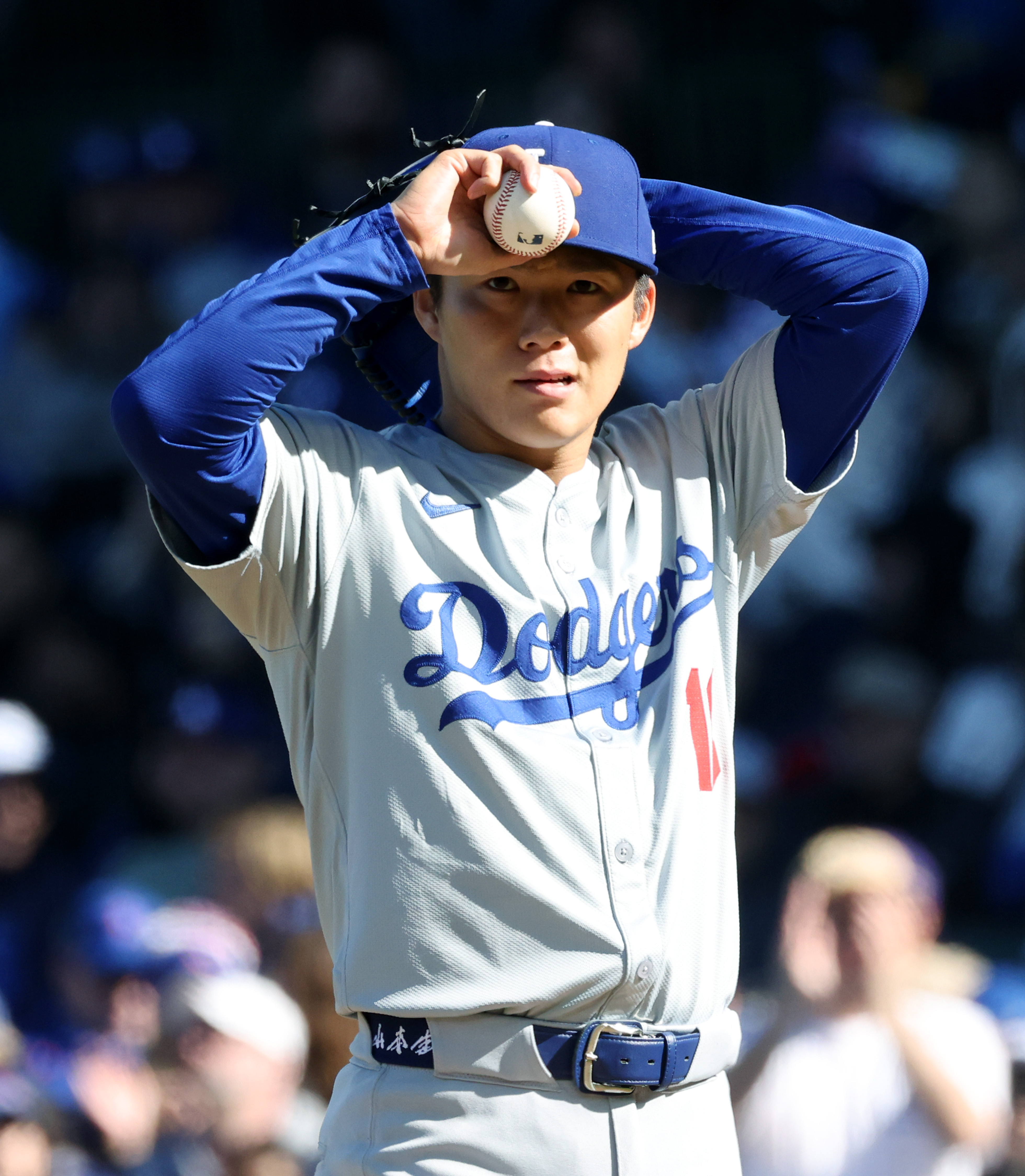 Dodgers pitcher Yoshinobu Yamamoto adjusts his cap during a game against the Cubs in the second inning on April 6, 2024, at Wrigley Field. (John J. Kim/Chicago Tribune)
