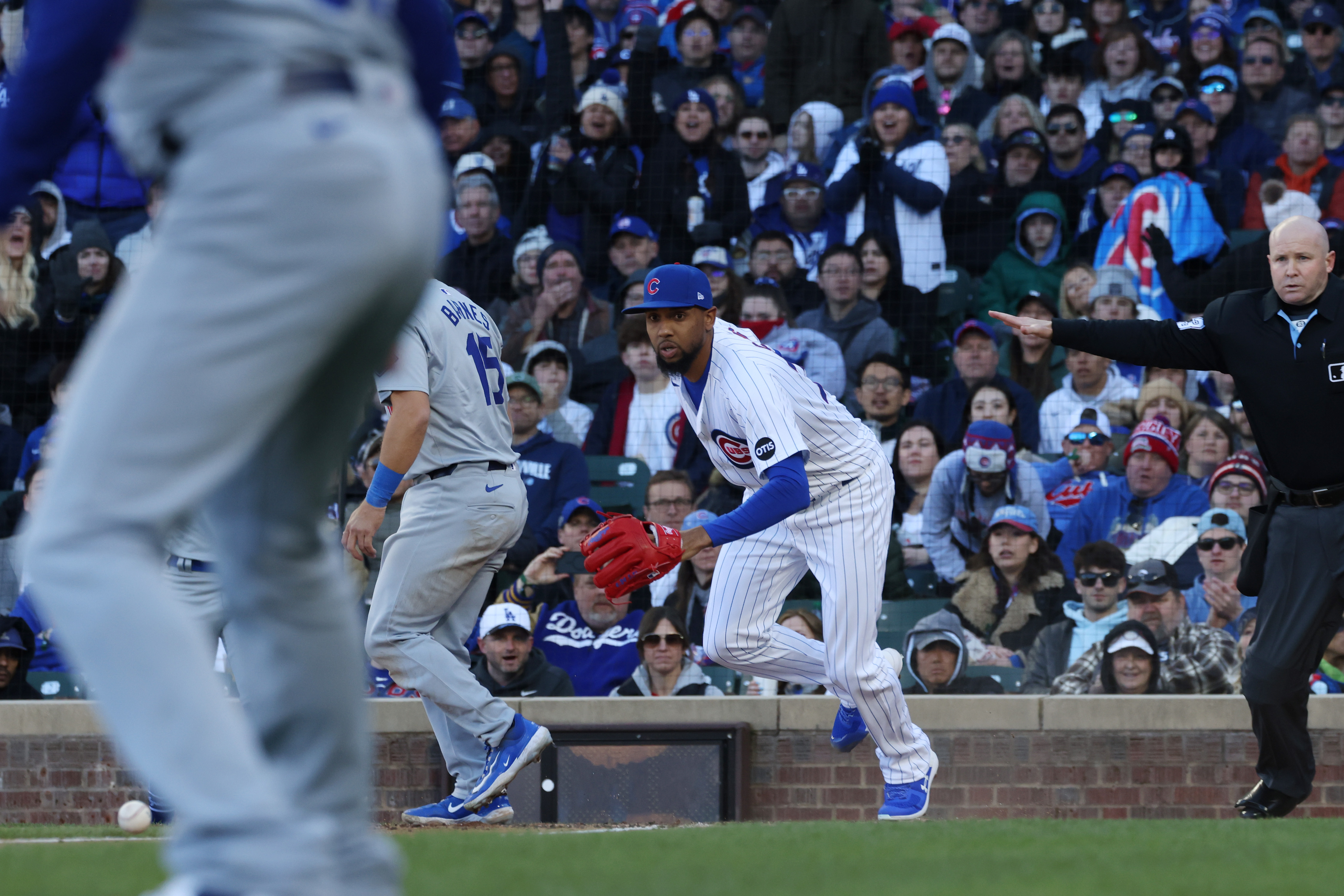 Cubs reliever Jose Cuas (74), center, scrambles at the plate after throwing a wild pitch, resulting in a Dodgers run in the fifth inning on April 6, 2024, at Wrigley Field. (John J. Kim/Chicago Tribune)