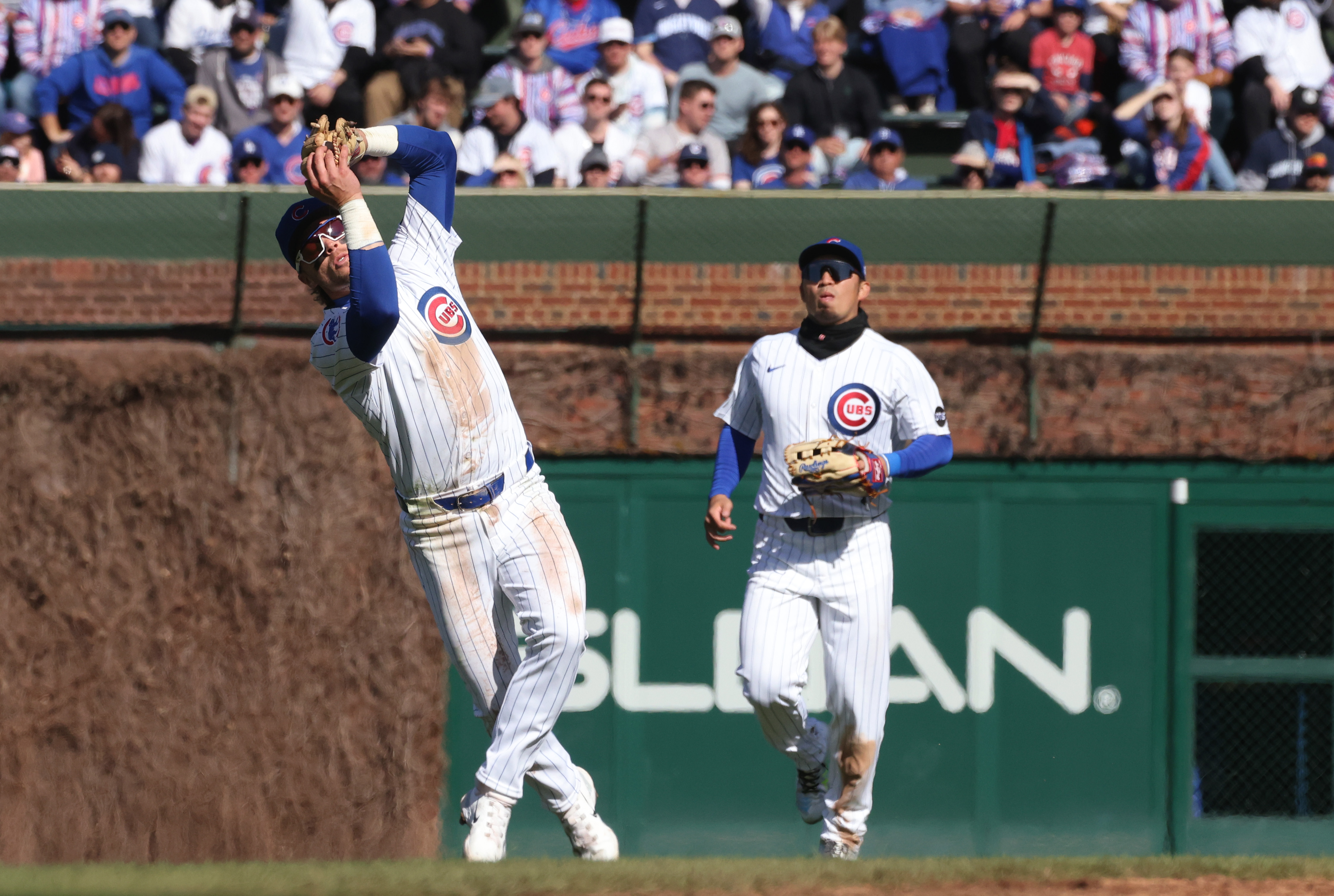 Cubs second baseman Nico Hoerner (2), left, catches a pop up to end the top of the third inning against the Dodgers at Wrigley Field on April 6, 2024, in Chicago. (John J. Kim/Chicago Tribune)