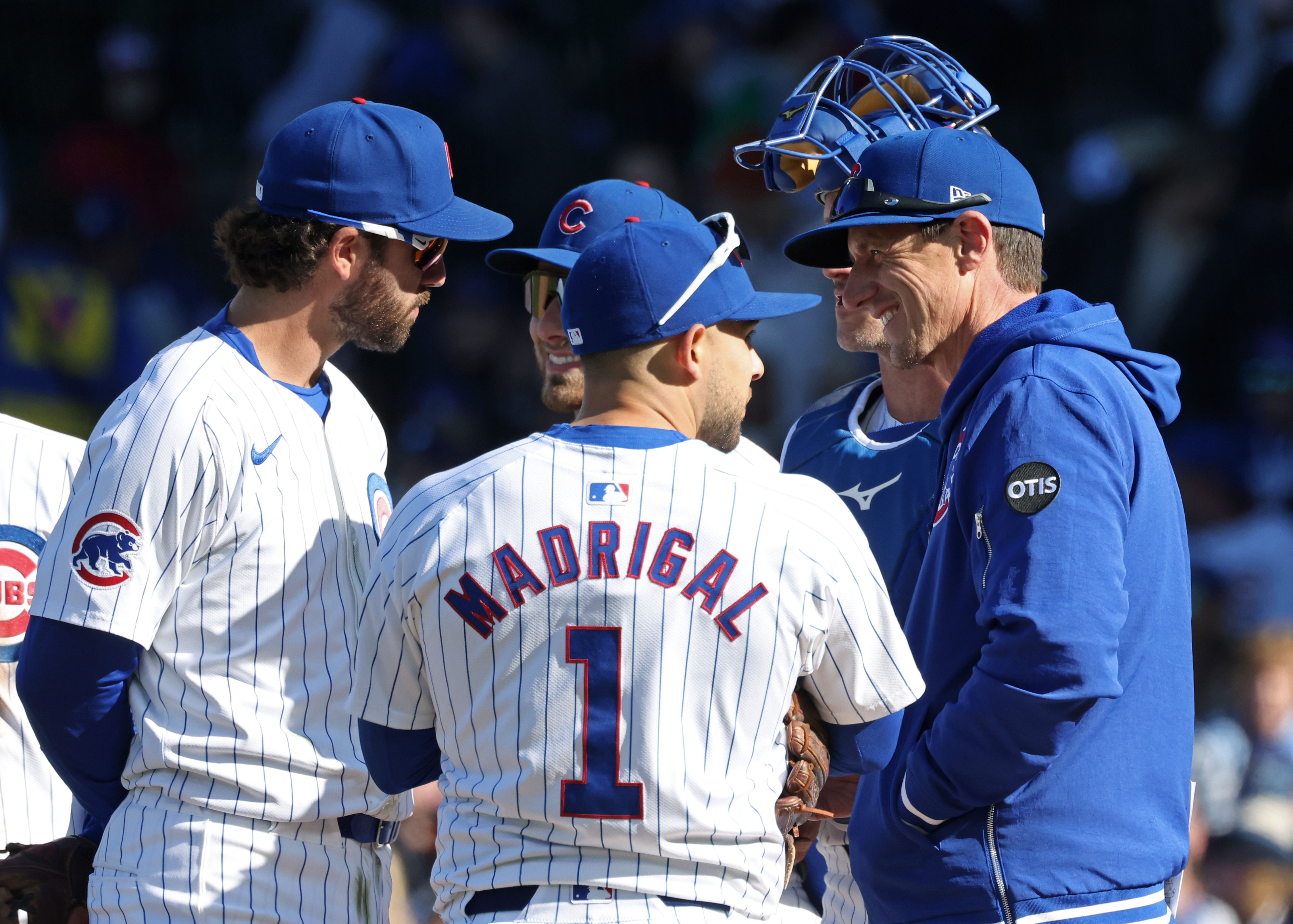 Cubs manager Craig Counsell, right, waits with players during a pitching change in the fifth inning against the Dodgers at Wrigley Field on April 6, 2024, in Chicago. (John J. Kim/Chicago Tribune)