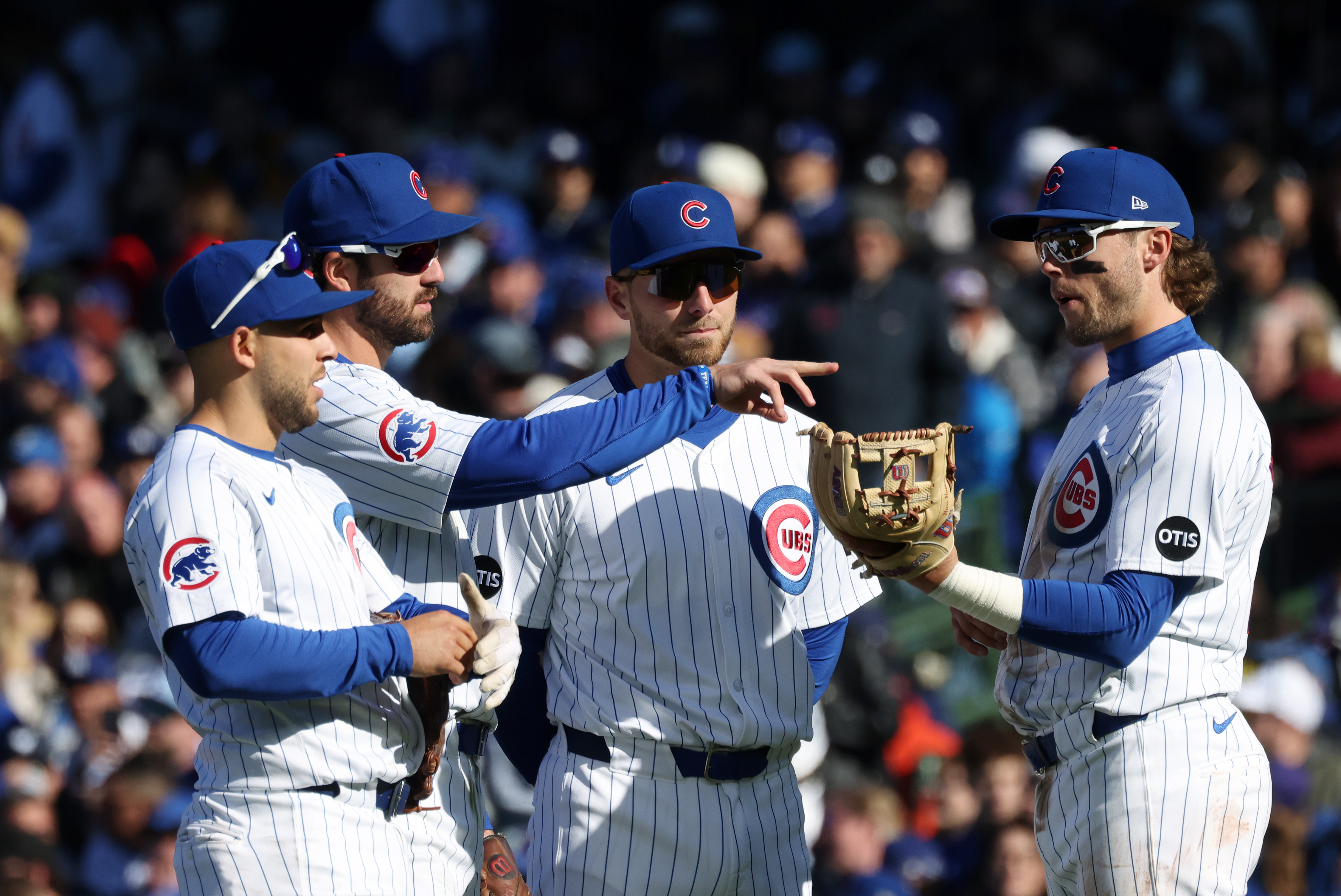 Cubs infielders talk during a pitching change in the fifth inning against the Dodgers at Wrigley Field on April 6, 2024, in Chicago. (John J. Kim/Chicago Tribune)