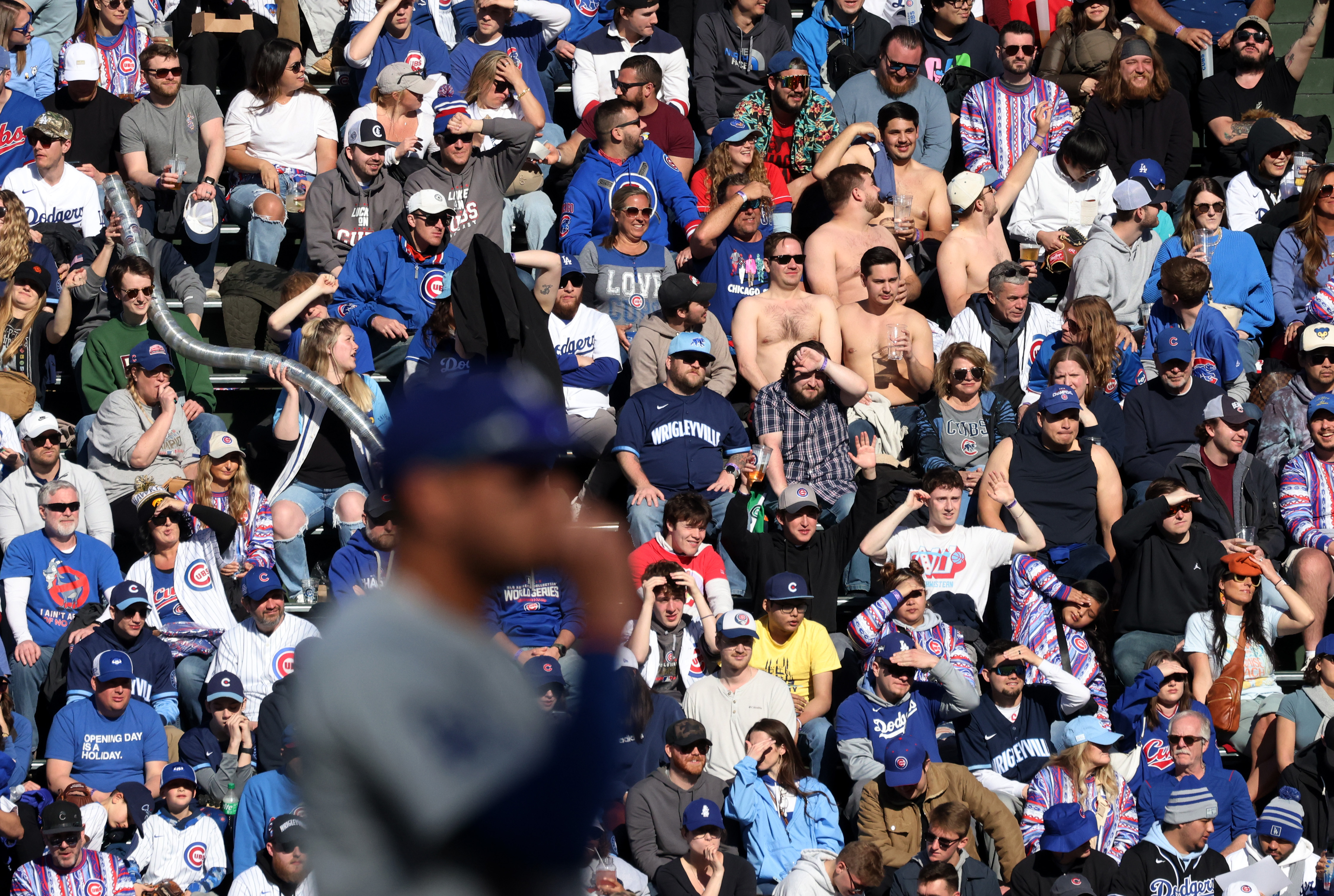 A quintet of shirtless fans sit in the right-field bleachers in the sixth inning between the Cubs and Dodgers at Wrigley Field on April 6, 2024, in Chicago. (John J. Kim/Chicago Tribune)