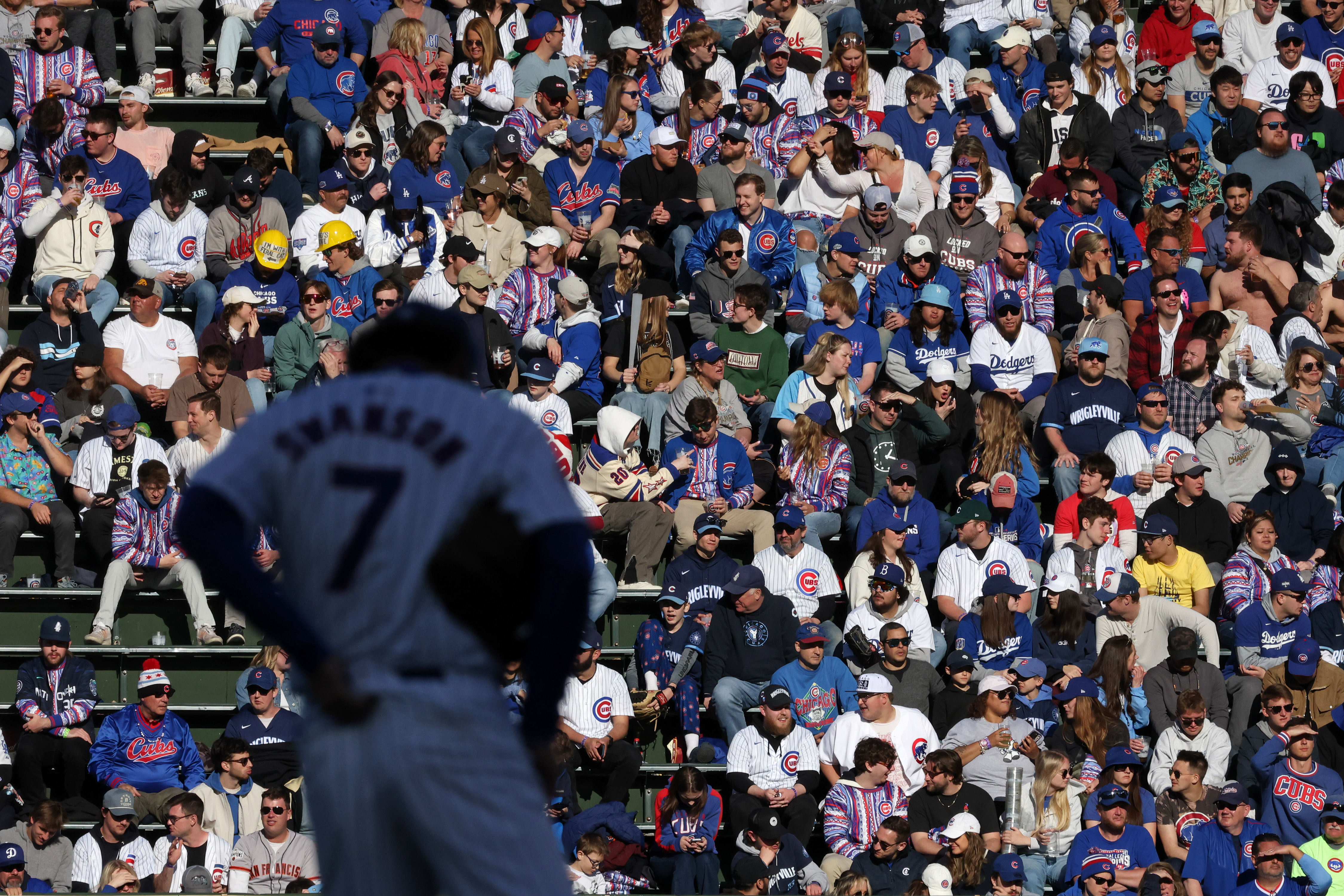 The infield shadow covers Cubs shortstop Dansby Swanson (7) as bleacher fans sit in the sun in the eighth inning against the Dodgers at Wrigley Field on April 6, 2024, in Chicago. (John J. Kim/Chicago Tribune)