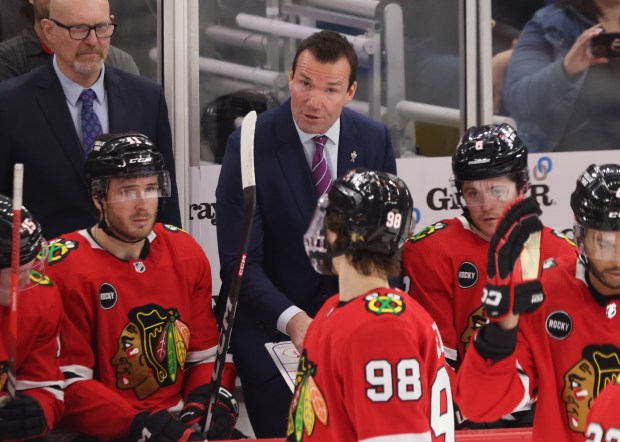 Blackhawks coach Luke Richardson talks to center Connor Bedard (98) during a timeout in the third period against the Flyers at the United Center on Feb. 21, 2024, in Chicago. (John J. Kim/Chicago Tribune)