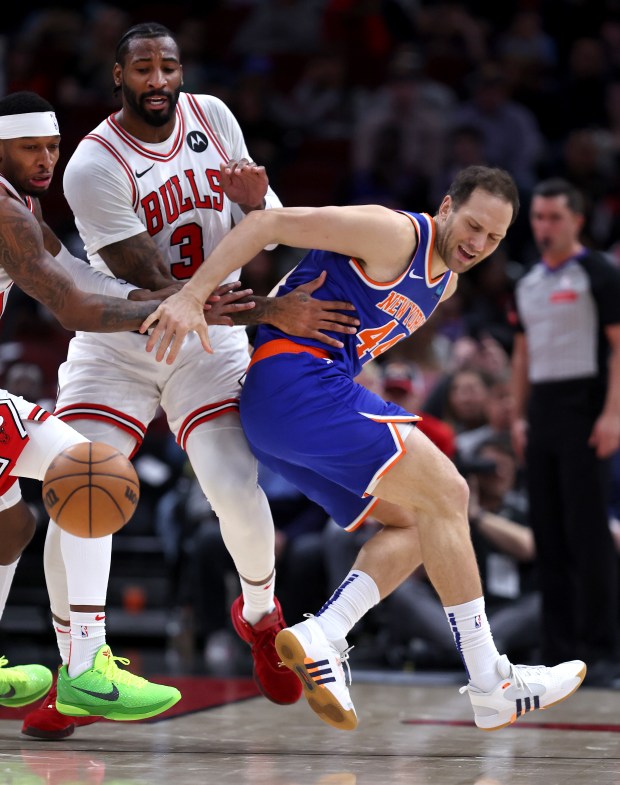 Chicago Bulls center Andre Drummond (3) and New York Knicks forward Bojan Bogdanovic (44) look to get control of a loose ball in the first half of a game at the United Center in Chicago on April 9, 2024. (Chris Sweda/Chicago Tribune)