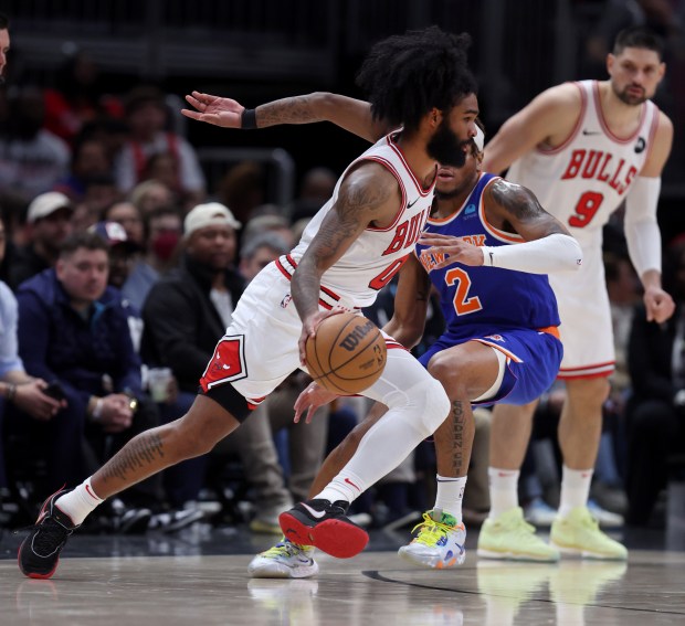 Chicago Bulls guard Coby White (0) drives on New York Knicks guard Miles McBride (2) in the second half of a game at the United Center in Chicago on April 9, 2024. (Chris Sweda/Chicago Tribune)