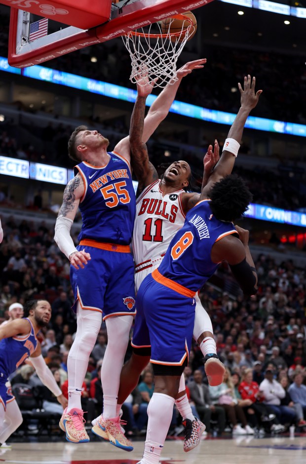 Chicago Bulls forward DeMar DeRozan (11) fails to score a bucket as New York Knicks center Isaiah Hartenstein (55) and guard DaQuan Jeffries (8) apply pressure in the first half of a game at the United Center in Chicago on April 9, 2024. (Chris Sweda/Chicago Tribune)
