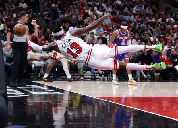 Chicago Bulls forward Torrey Craig (13) tries to save a ball from going out of bounds in the first half of a game against the New York Knicks at the United Center in Chicago on April 9, 2024. (Chris Sweda/Chicago Tribune)