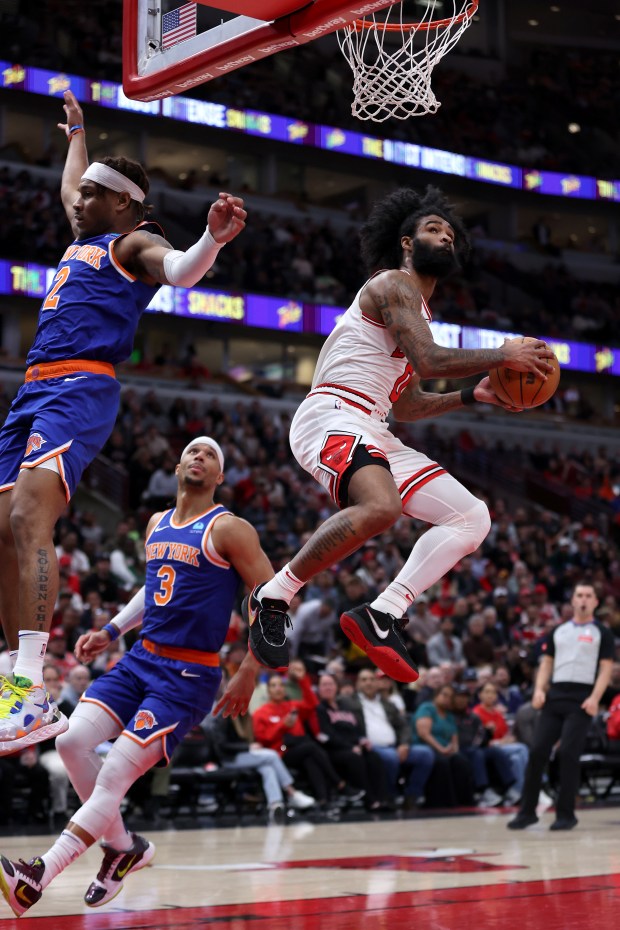 Chicago Bulls guard Coby White (0) hangs in the air as he attempts a layup in the first half of a game against the New York Knicks at the United Center in Chicago on April 9, 2024. (Chris Sweda/Chicago Tribune)