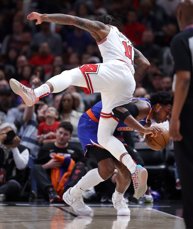 Chicago Bulls forward DeMar DeRozan (11) falls into New York Knicks guard DaQuan Jeffries (8) in the first half of a game at the United Center in Chicago on April 9, 2024. (Chris Sweda/Chicago Tribune)