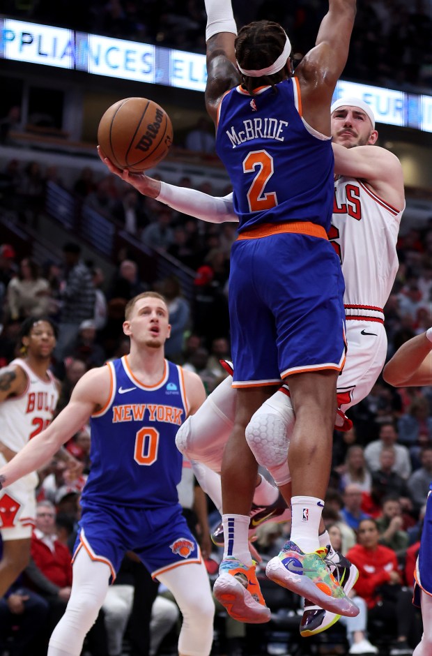 Chicago Bulls guard Alex Caruso (6) passes around New York Knicks guard Miles McBride (2) in the first half of a game at the United Center in Chicago on April 9, 2024. (Chris Sweda/Chicago Tribune)