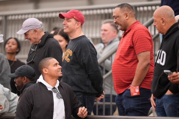 Bears general manager Ryan Poles, left, speaks with Carl Williams, father of USC quarterback Caleb Williams, at the school's pro day on March 20, 2024, in Los Angeles. (AP Photo/Ryan Sun)