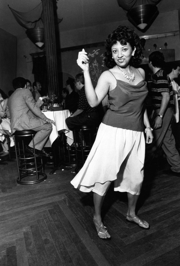 Maria Elena De La Cruz dances at Cairo's dance club on Tropical Tuesday night in Chicago on July 3, 1990. De La Cruz works at the Mexican Consulate. (John Kringas/for the Chicago Tribune) scanned from print, published on July 11, 1990.