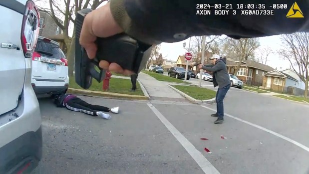 A still image of a video released by the Civilian Office of Police Accountability shows a group of Chicago police officers surrounding a vehicle driven by Dexter Reed, 26, moments before an "exchange of gunfire" in which Reed was fatally shot on March 21, 2024 in the Humboldt Park neighborhood. (Chicago Police Department)