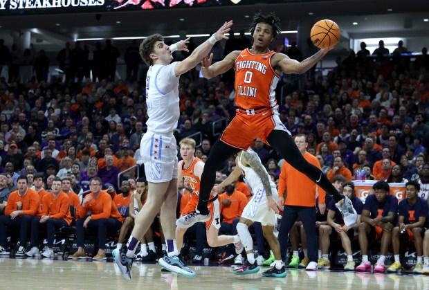 Northwestern forward Nick Martinelli, 2, applies pressure as Illinois guard Terrence Shannon Jr., 0, passes to a teammate in the second half of a game at Welsh-Ryan Arena in Evanston on Jan. 24, 2024. (Chris Sweda/Chicago Tribune)