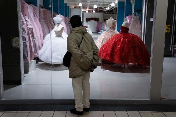 A mall walker looks at gowns in JCK's Boutique in the Spring Hill Mall in West Dundee, which is closing after 43 years. Photographed Wednesday, March 20, 2024. (E. Jason Wambsgans/Chicago Tribune)